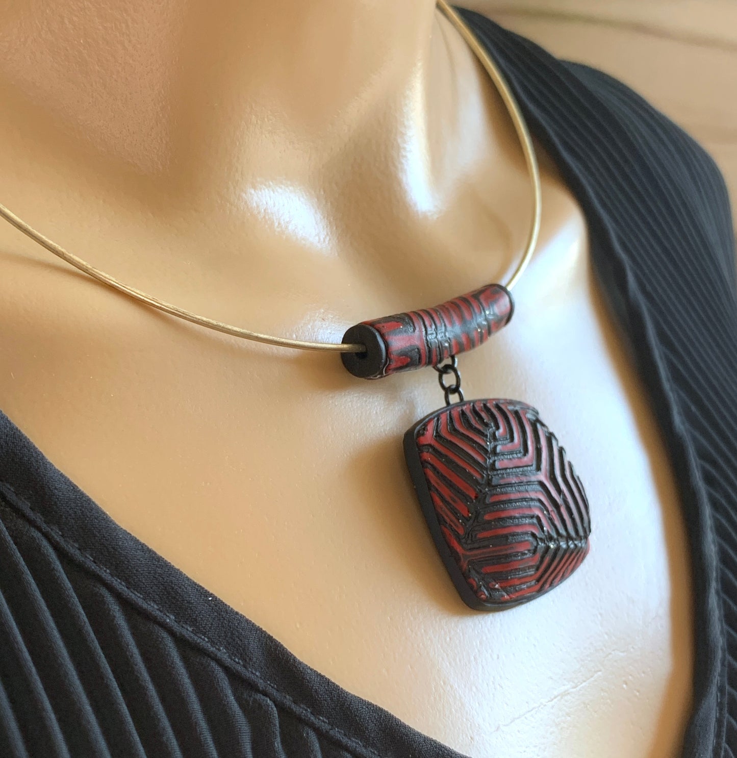 Red and black geometric pendant and earring set