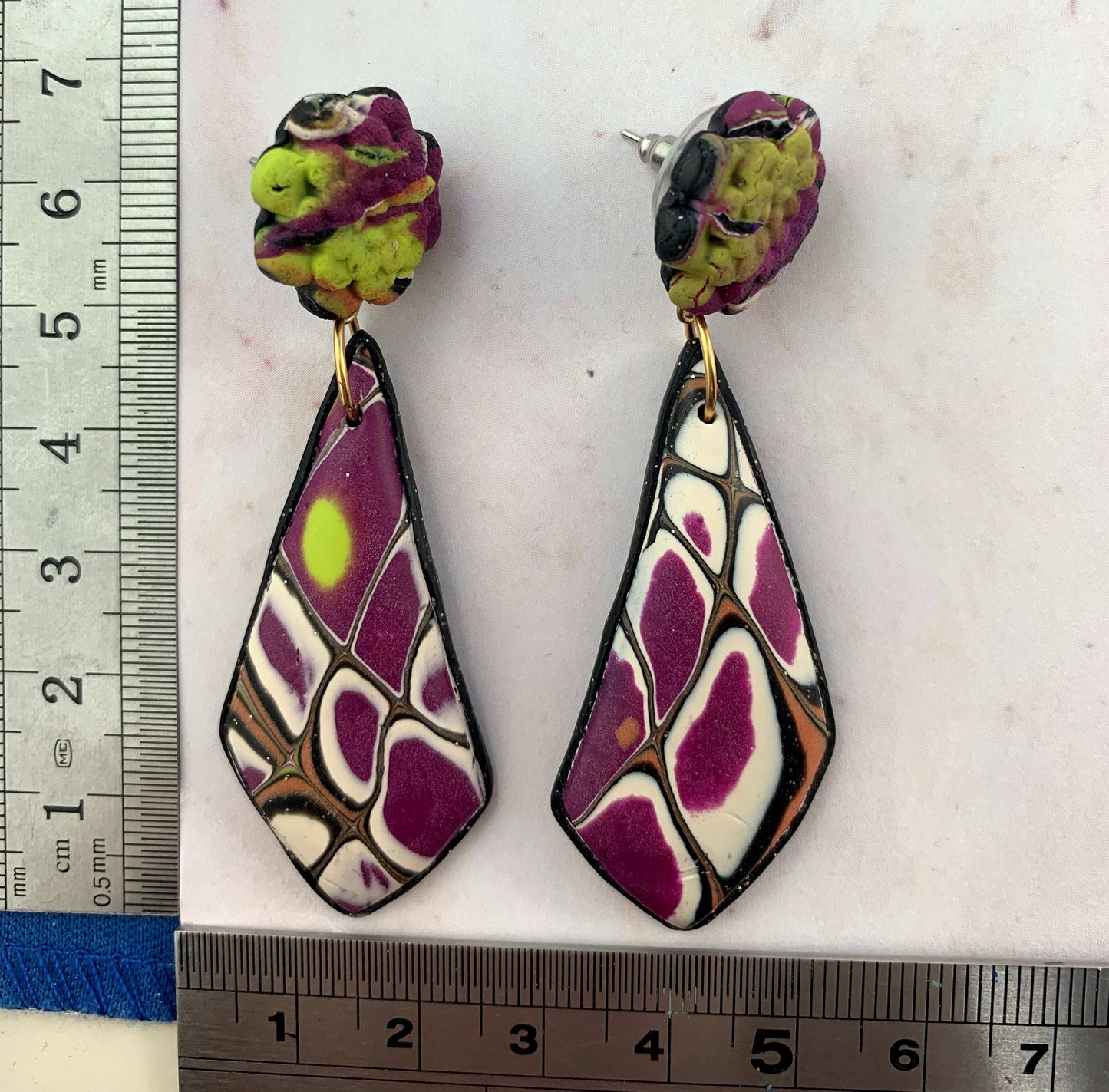 Handmade long earrings shown with ruler for accurate size reference and scale.