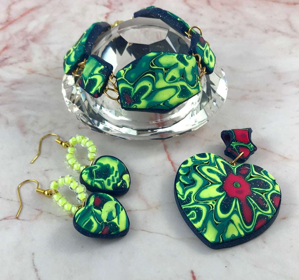 Handmade Colour Burst Flower polymer clay jewellery set with statement heart pendant, matching bracelet and heart earrings in bold neon green, navy and pink, artisan jewellery Australia