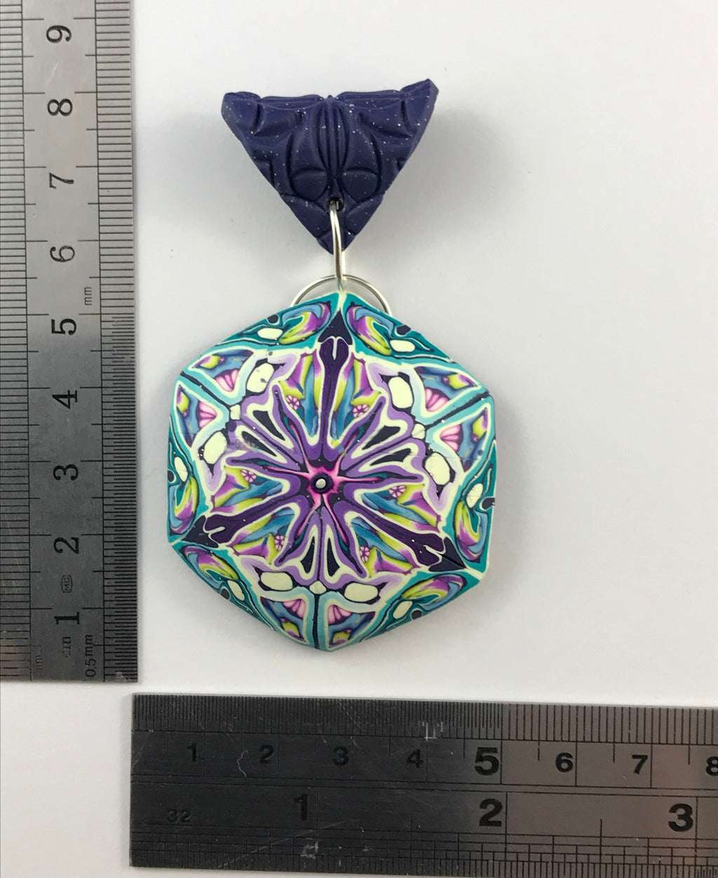 Handmade floral polymer clay pendant necklace styled for Shopify product display with pastel blue and purple pattern