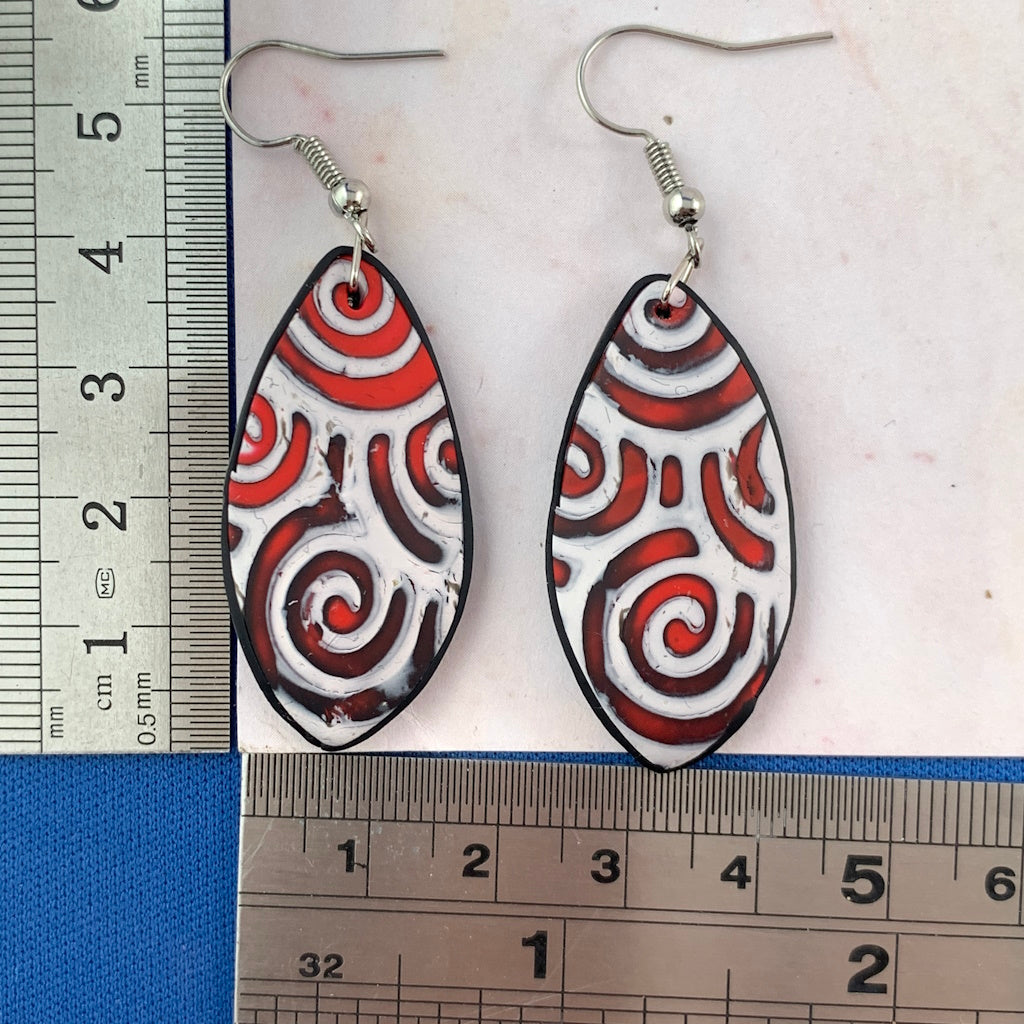 Red and white teardrop statement earrings with ruler for size comparison
