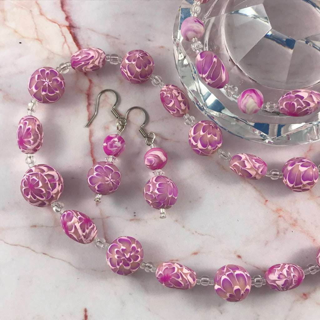 Long pink flower polymer clay necklace set with matching bracelet and earrings, handmade one-of-a-kind Rennique jewellery.