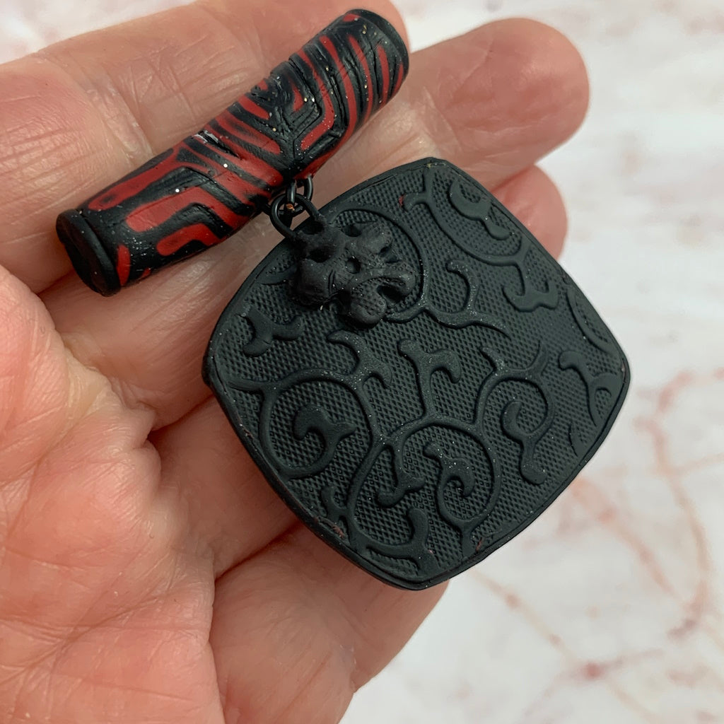 Red and black geometric pendant and earring set