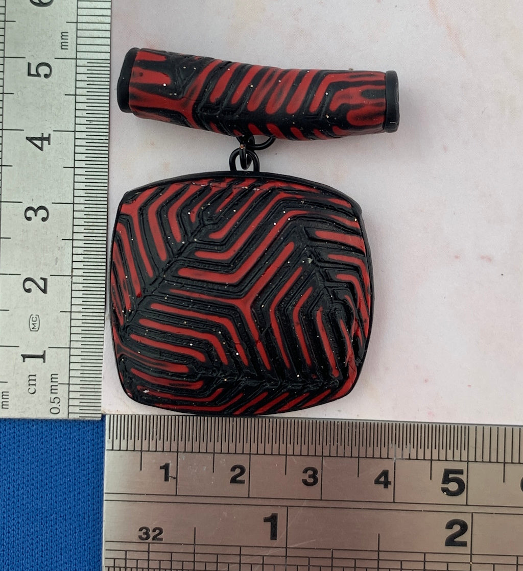 Red and black geometric pendant and earring set