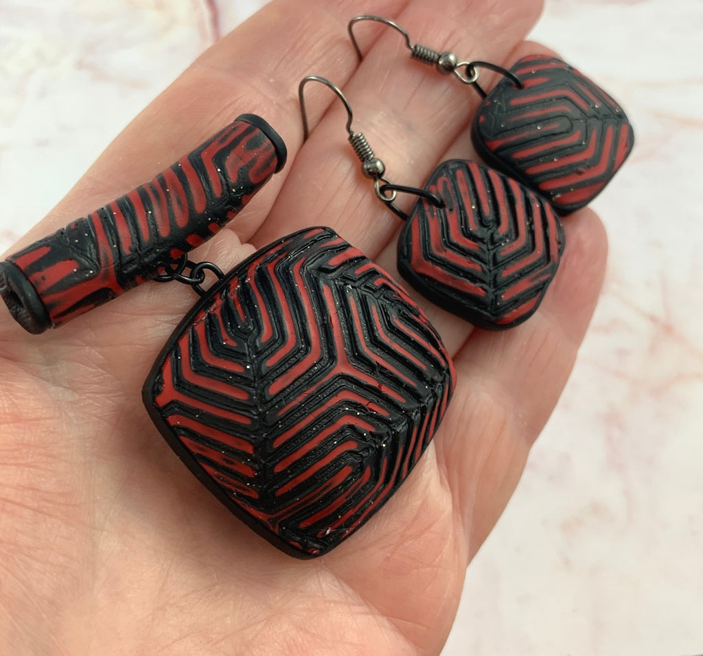 Red and black geometric pendant and earring set