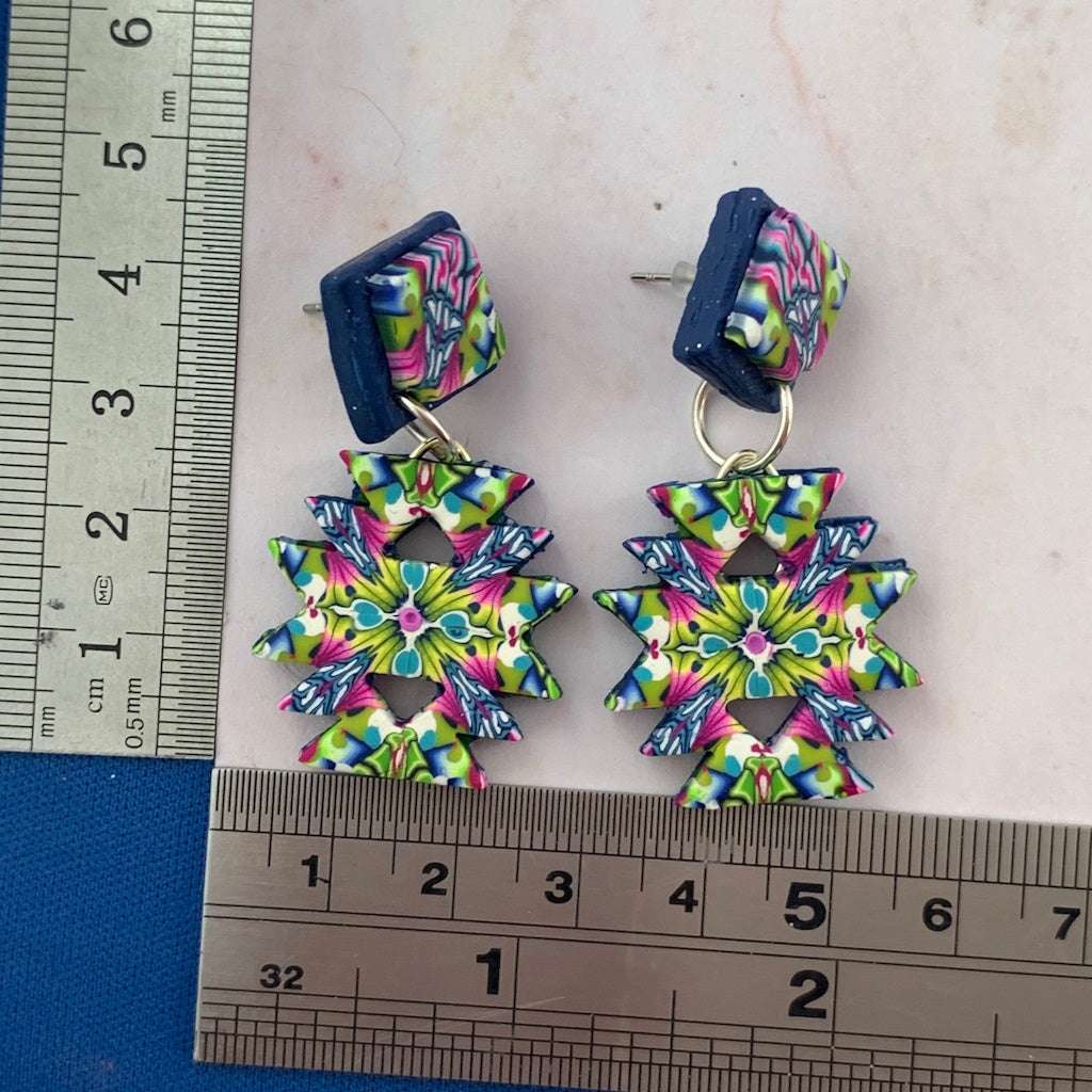 Australian artist made colourful Aztec inspired statement earrings with ruler size guide showing dimensions and geometric drop design.
