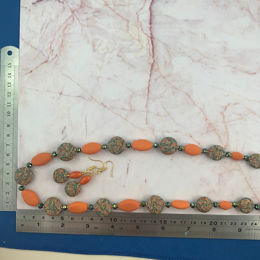 Long statement necklace with orange oval beads and multicolour marble pattern beads with matching earrings, handmade jewellery Australia