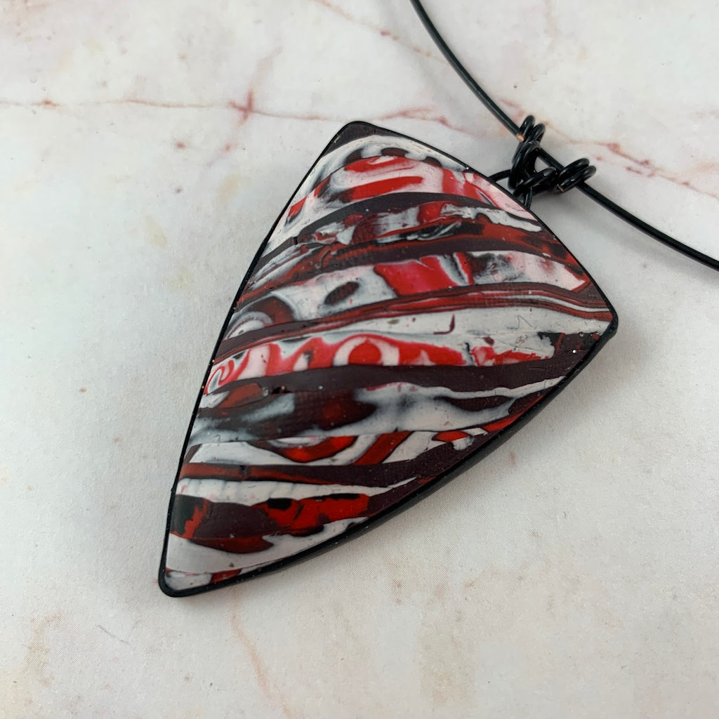 Award-winning Rennique hand-sculpted polymer clay statement necklace in red black abstract marbled geometric pendant design