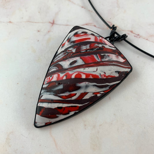 Award-winning Rennique hand-sculpted polymer clay statement necklace in red black abstract marbled geometric pendant design