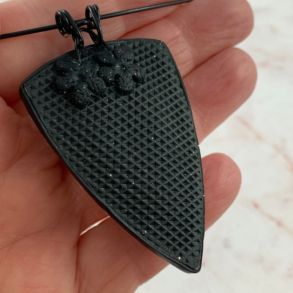 Award-winning Rennique polymer clay pendant necklace showing textured reverse finish artisan handcrafted detail