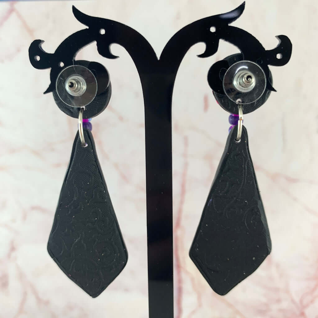 Back view of pink and purple polymer clay earrings showing secure post fittings and textured finish handmade in Australia