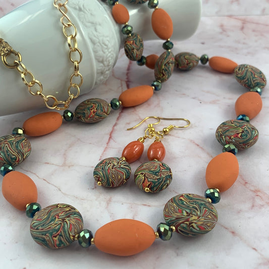Beautiful handmade long autumn tone necklace with orange oval beads, multicolour marble pattern beads and green crystal spacers with matching earrings, statement jewellery Australia