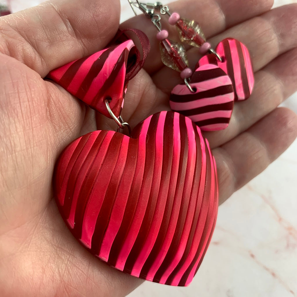 Bold handmade pink and red striped heart pendant necklace with matching earrings, artisan statement jewellery gift for women by Rennique.