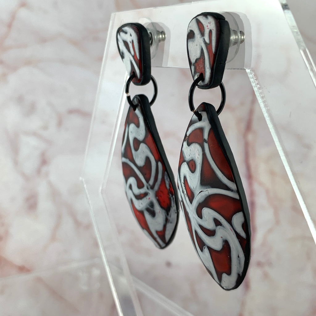 Close up of marbled red and white artisan drop earrings - Side View
