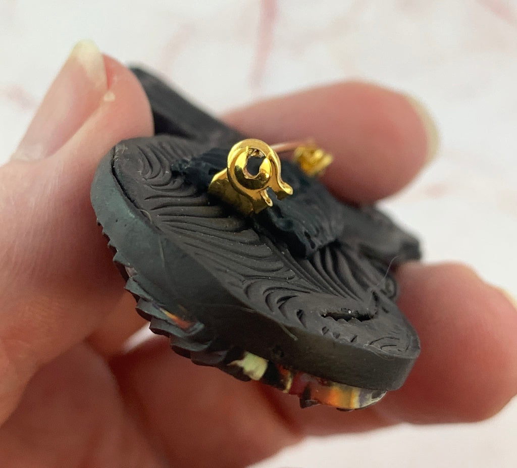 Close up of gold locking pin on handmade cat brooch, secure fastening jewellery detail