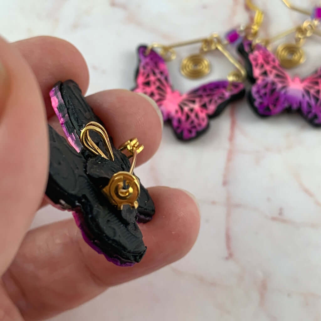 Close up of butterfly pendant brooch combination clasp with gold fitting, handmade artisan jewellery