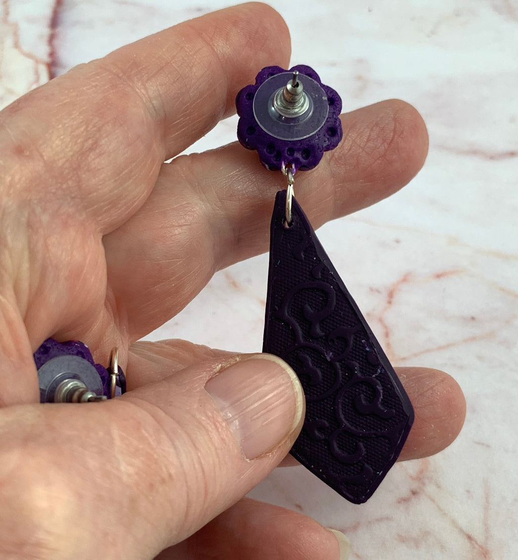 Handmade Rennique long purple marbled clay earrings with flower accent and bold statement drop design.