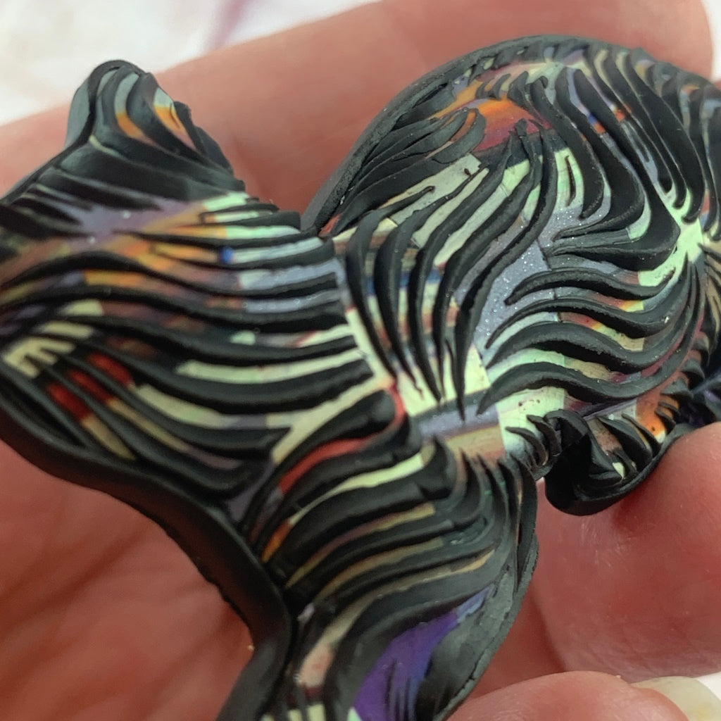 Handmade cat brooch with rounded 3D shape and textured surface resembling fur, artisan design