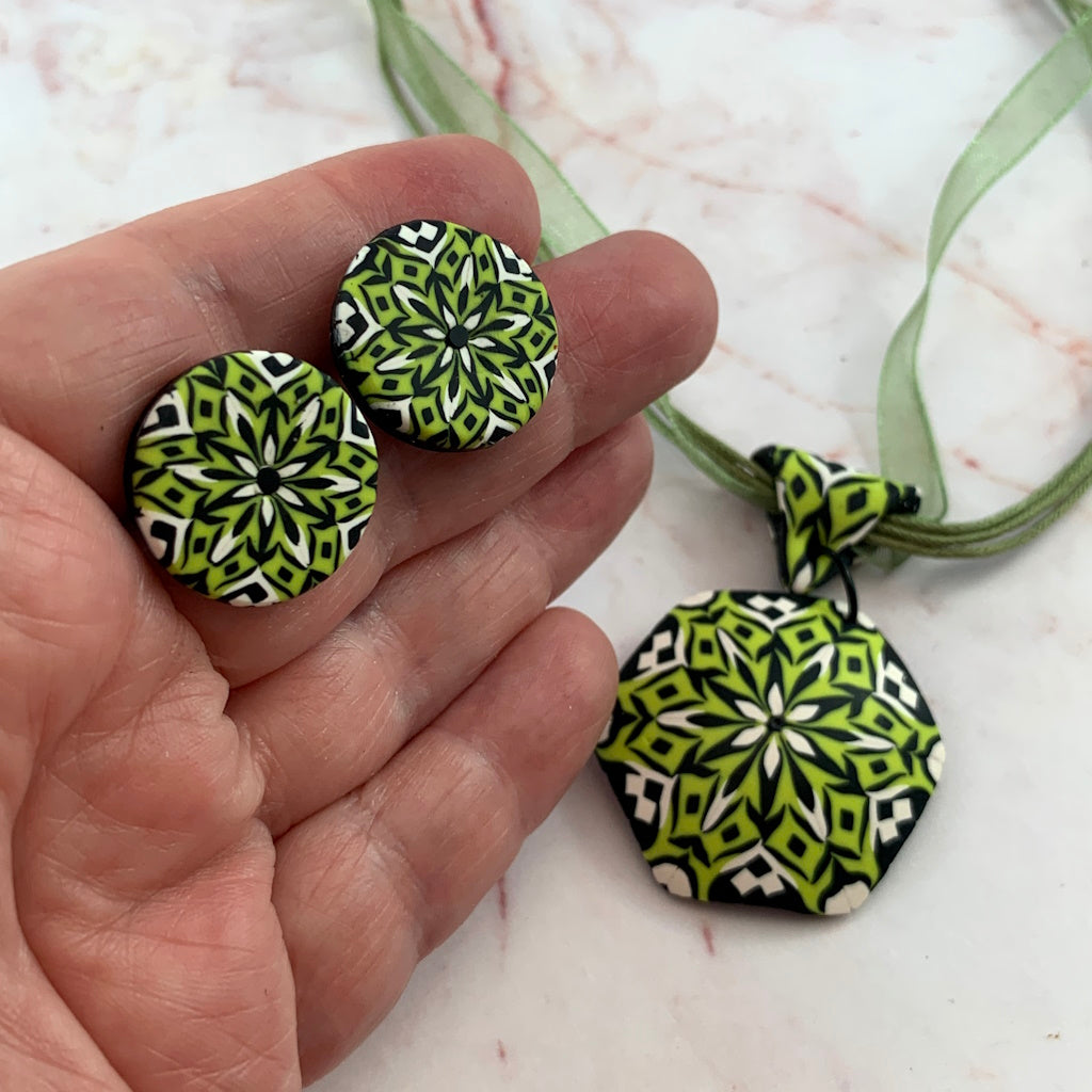 Rennique round polymer clay stud earrings in lime green, black and white kaleidoscope floral geometric pattern.