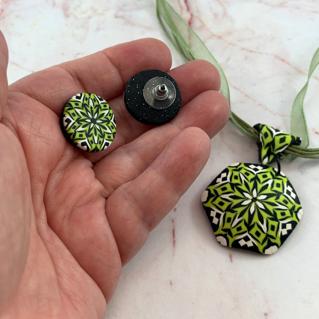Rennique handcrafted polymer clay stud earrings showing front mandala design and secure metal post backing.