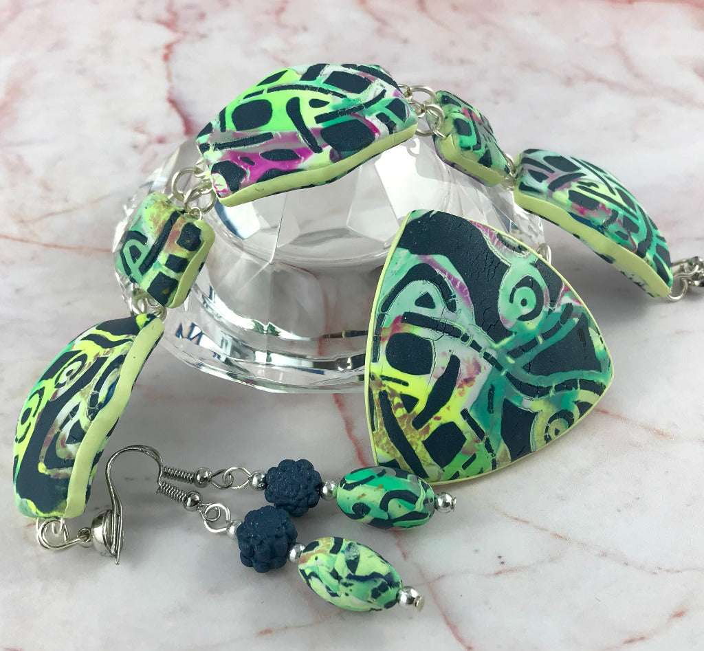 One of a kind handmade Melbourne laneway jewellery set featuring statement pendant necklace, matching earrings and bracelet in green, black and abstract graffiti polymer clay design, artisan jewellery Australia