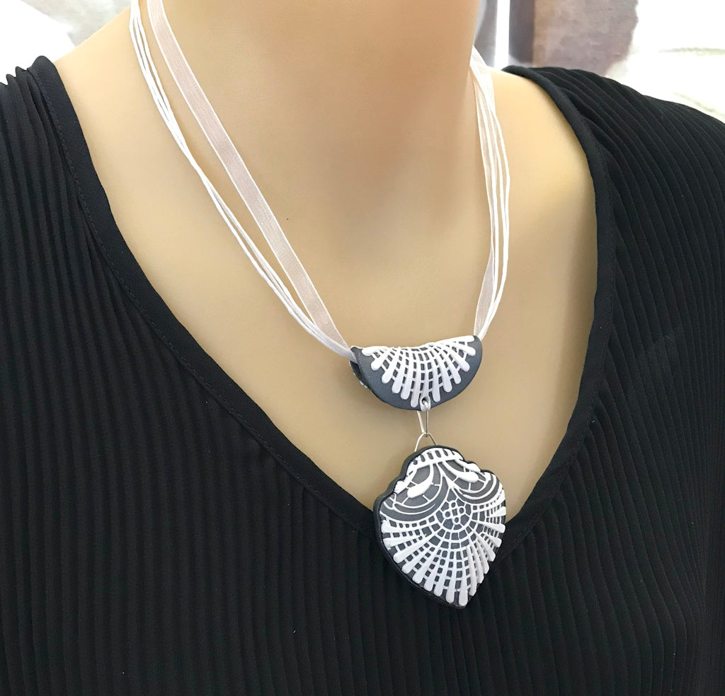 Handmade navy blue and white statement pendant featuring matching polymer clay bail and textured design.