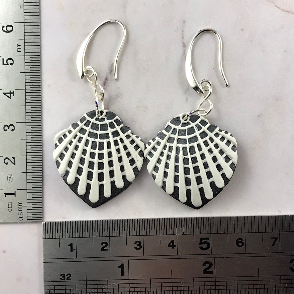 Handmade navy blue and white earrings shown with ruler for size reference.