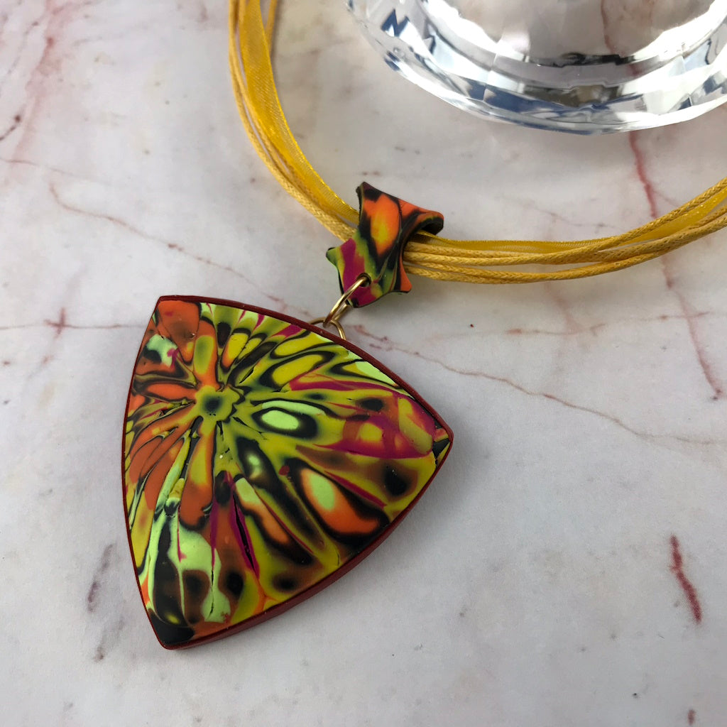 Handmade one-of-a-kind curved polymer clay pendant necklace with textured patterned surface by Rennique Australia.