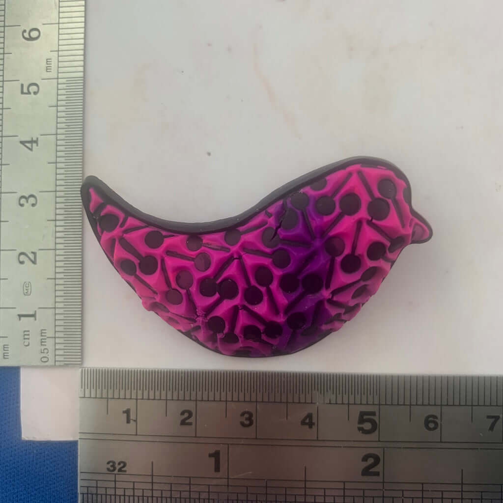 Pink and purple bird brooch statement jewellery handmade in Australia by Rennique, featuring raised polymer clay texture and curved design
