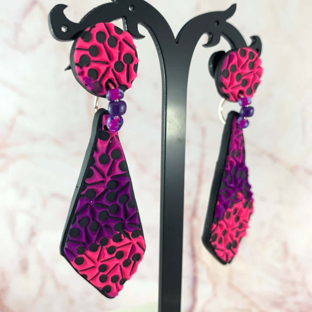Pink and purple statement earrings with decorative glass seed beads and raised polymer clay pattern handmade in Australia