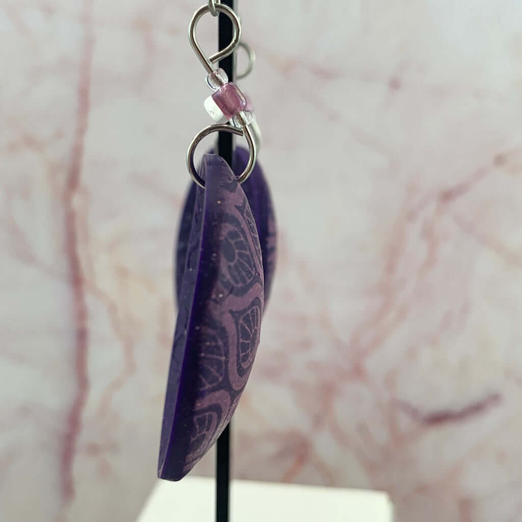 Side view of pink purple feature earrings showing thickness and lightweight polymer clay design handmade jewellery