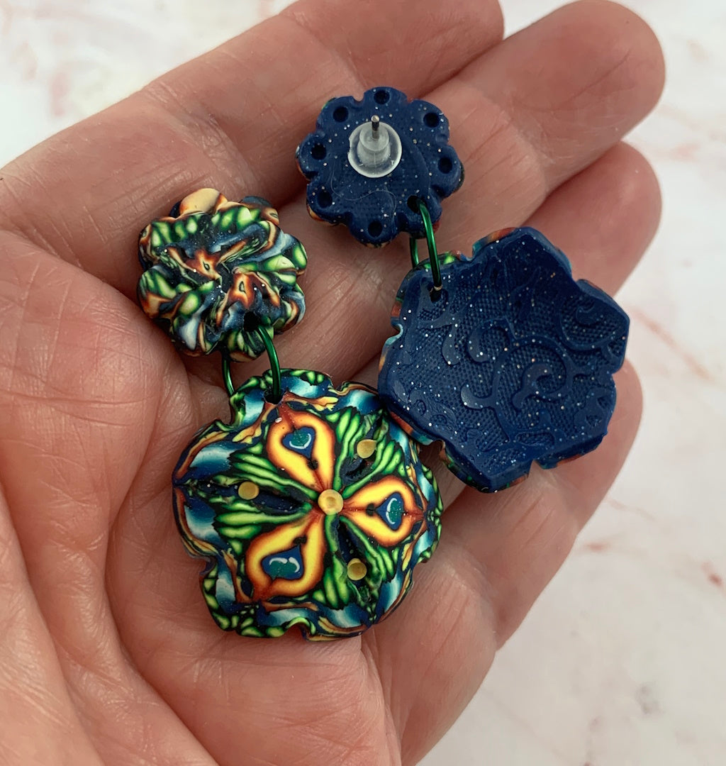 Front and back detail of Australian handmade Rennique statement earrings with embossed reverse finish and floral front design.