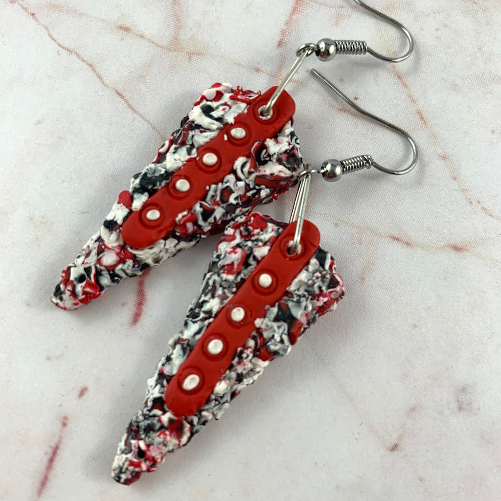 Rennique artisan polymer clay earrings with avant-garde monochrome texture and striking crimson accent detail