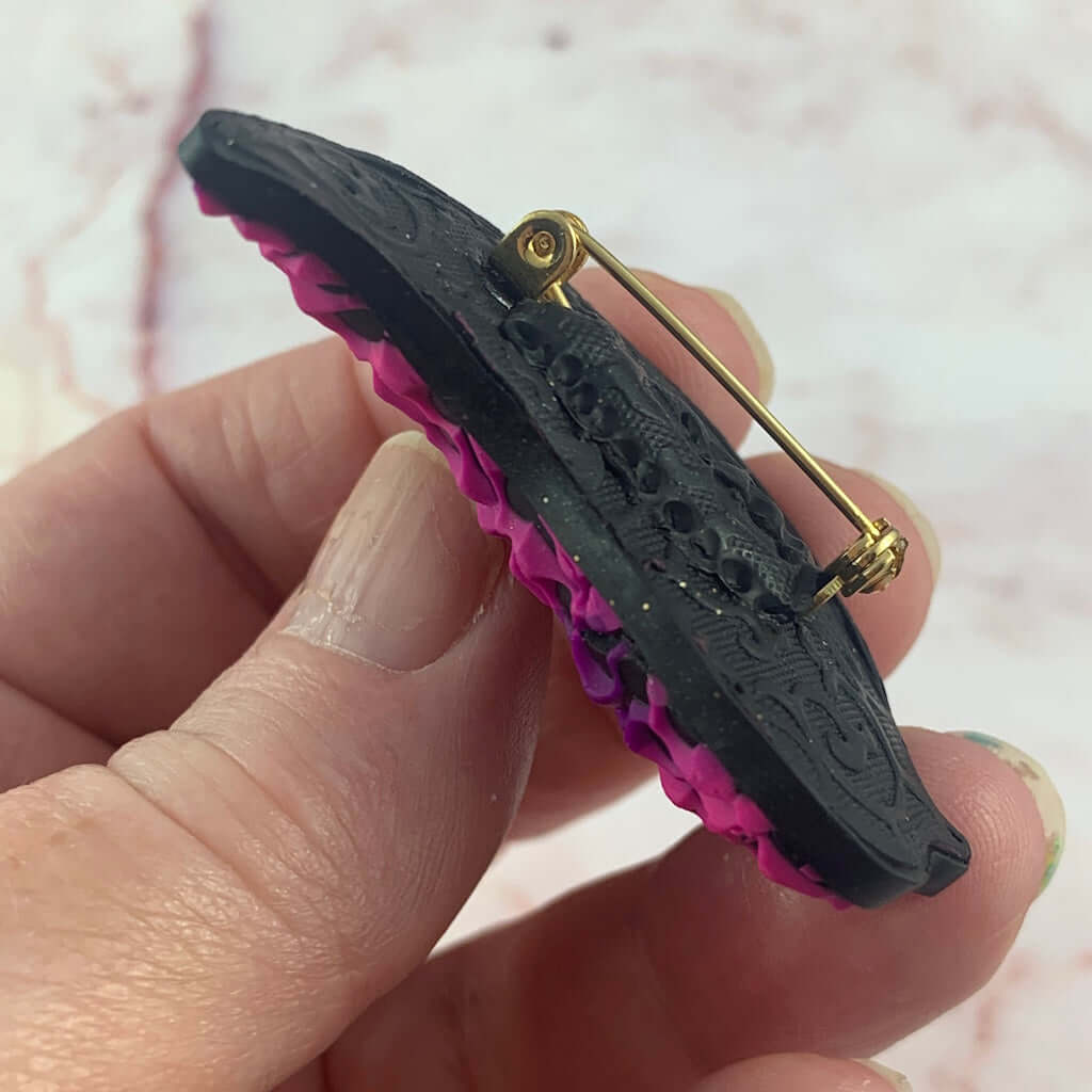 Back view of Rennique bird brooch with textured finish and secure clasp, handmade polymer clay jewellery Australia