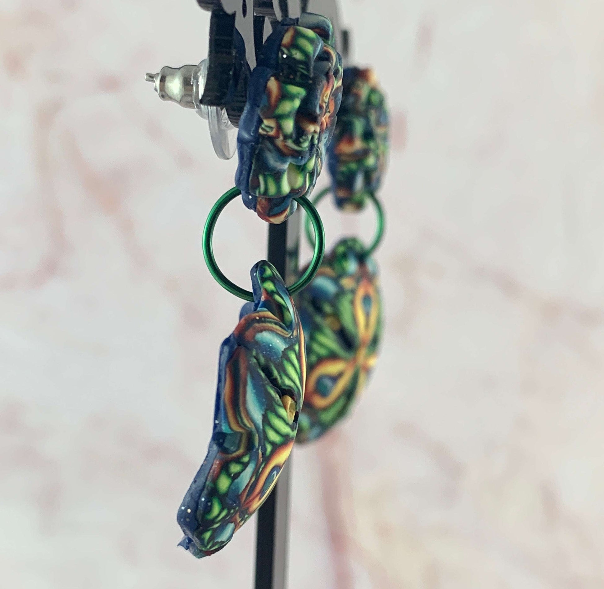 Side profile of Australian artist made Rennique floral statement earrings showing gently curved handcrafted polymer clay design.