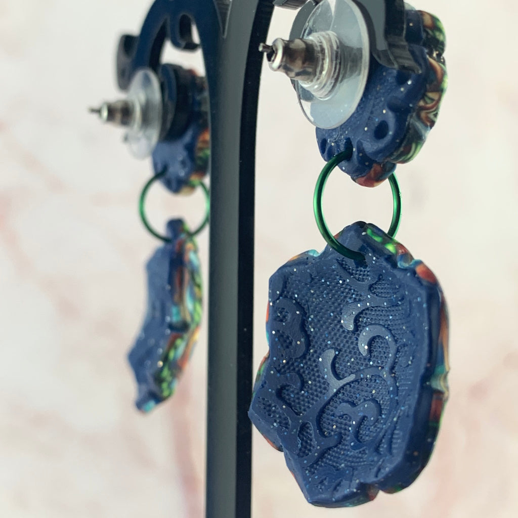 Back and side view of Australian handmade Rennique polymer clay statement earrings with embossed navy finish and green hoop connector.