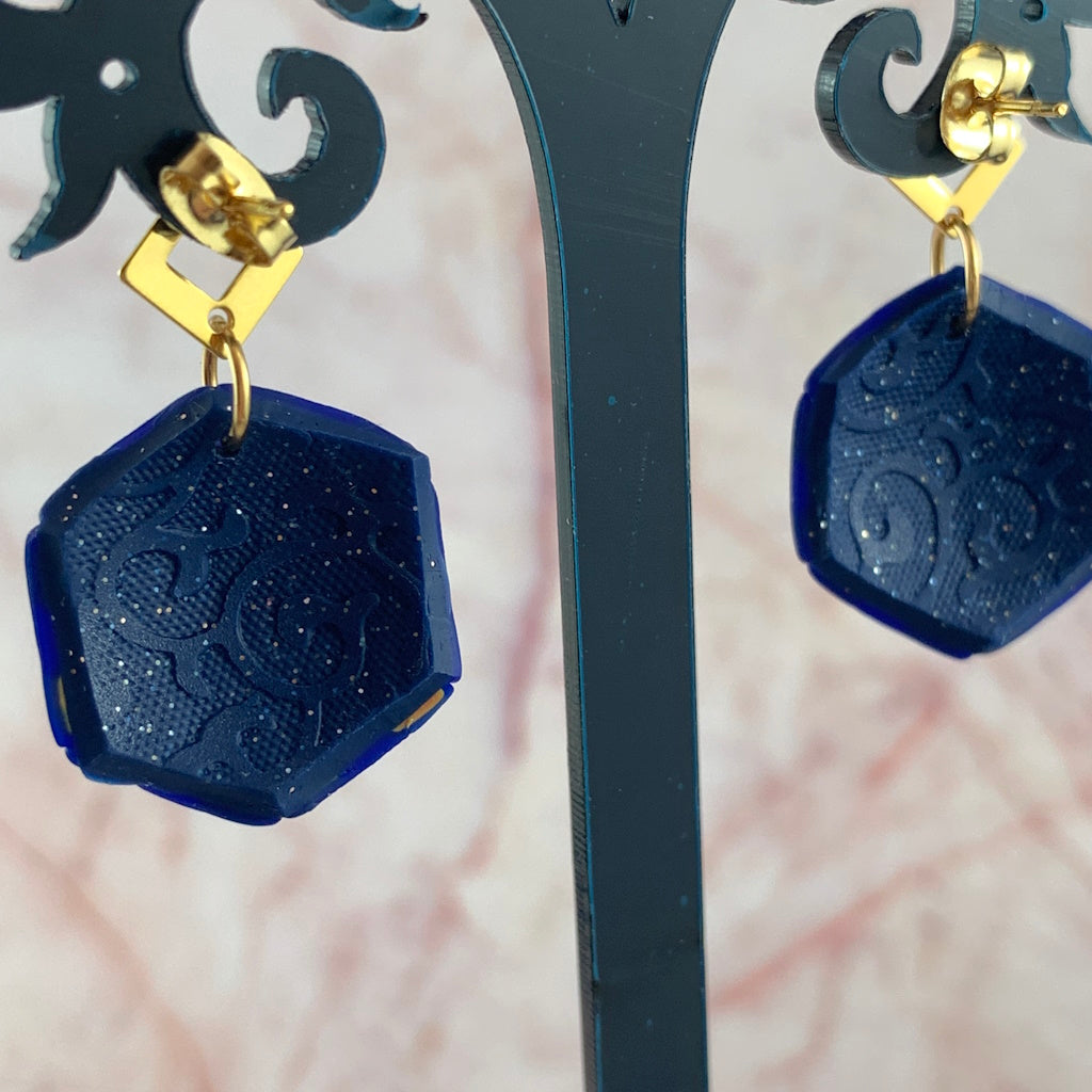 Embossed back detail of handmade blue polymer clay earrings by Rennique with subtle shimmer texture.