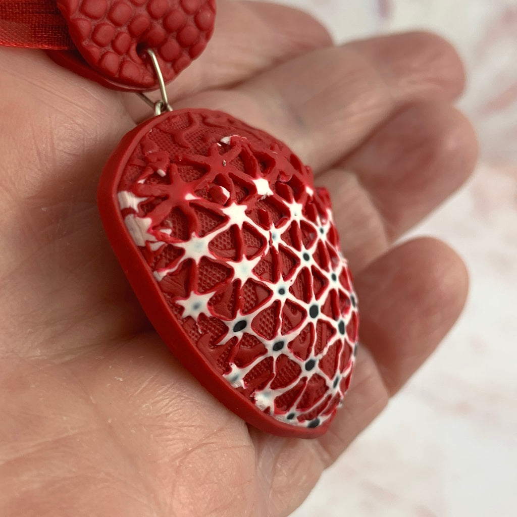 Rennique Australian artist made statement polymer clay necklace in bold crimson with high-contrast lace pattern
