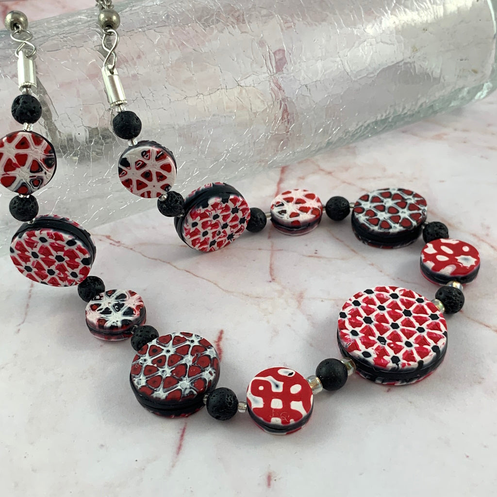 Rennique kaleidoscope of color polymer clay necklace bead detail red black white geometric handcrafted jewellery