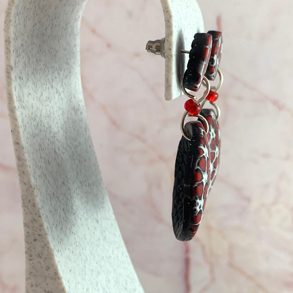 Rennique mokume ganae earrings side view designer clay jewelry lightweight handmade statement earrings red black white textured finish