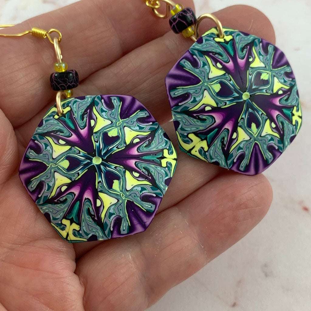 Rennique Studio wearable art earrings in purple green and yellow tones, bold statement polymer clay jewellery