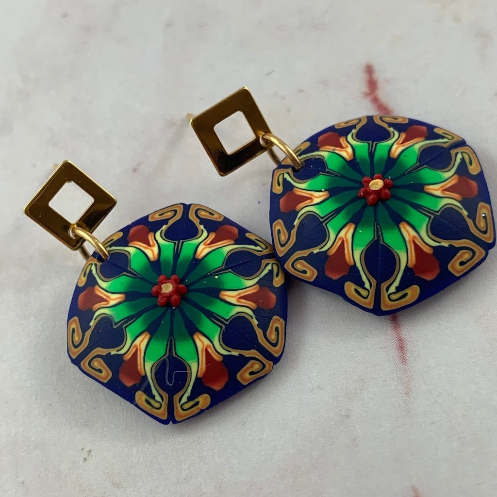 Handmade Rennique blue and green tropical bloom statement earrings with gold geometric studs and floral mandala design.