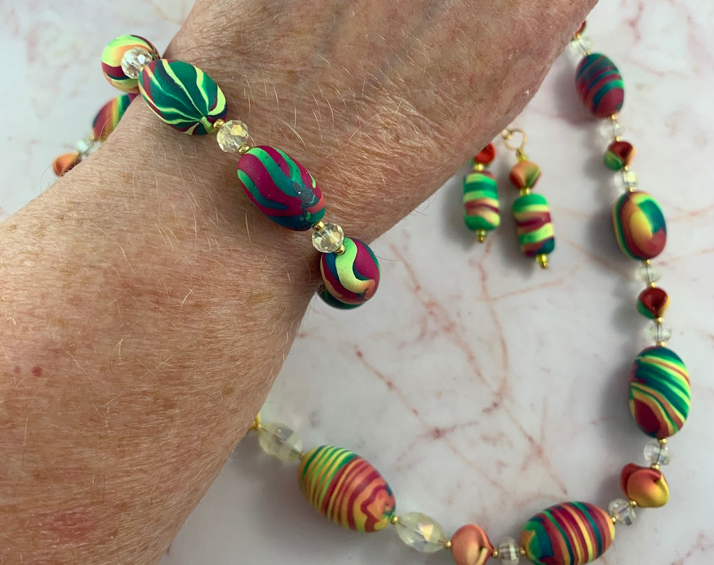 Rennique handcrafted colourful matching necklace and bracelet jewellery set with striped polymer clay beads, crystal accents and gold clasp, bold Australian handmade statement jewellery.