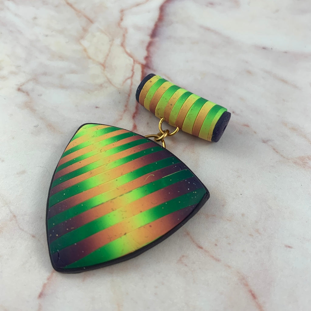 Hand sculpted ladies statement pendant by Rennique with bold green gold and purple striped design.