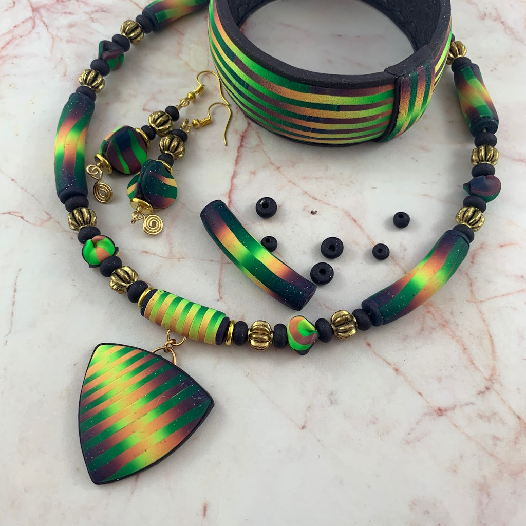 Award winning Rennique hand sculpted ladies jewellery set featuring necklace, pendant, matching earrings and bracelet in multicolour artisan design.