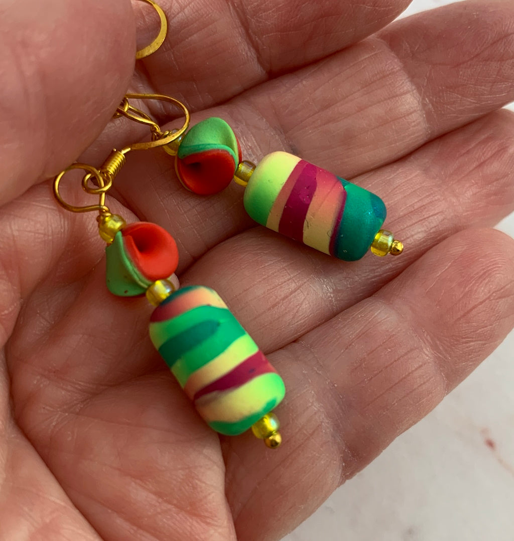Award winning Rennique hand sculpted multicolour drop earrings featuring vibrant striped artisan beads with gold hooks and bold statement design for women.