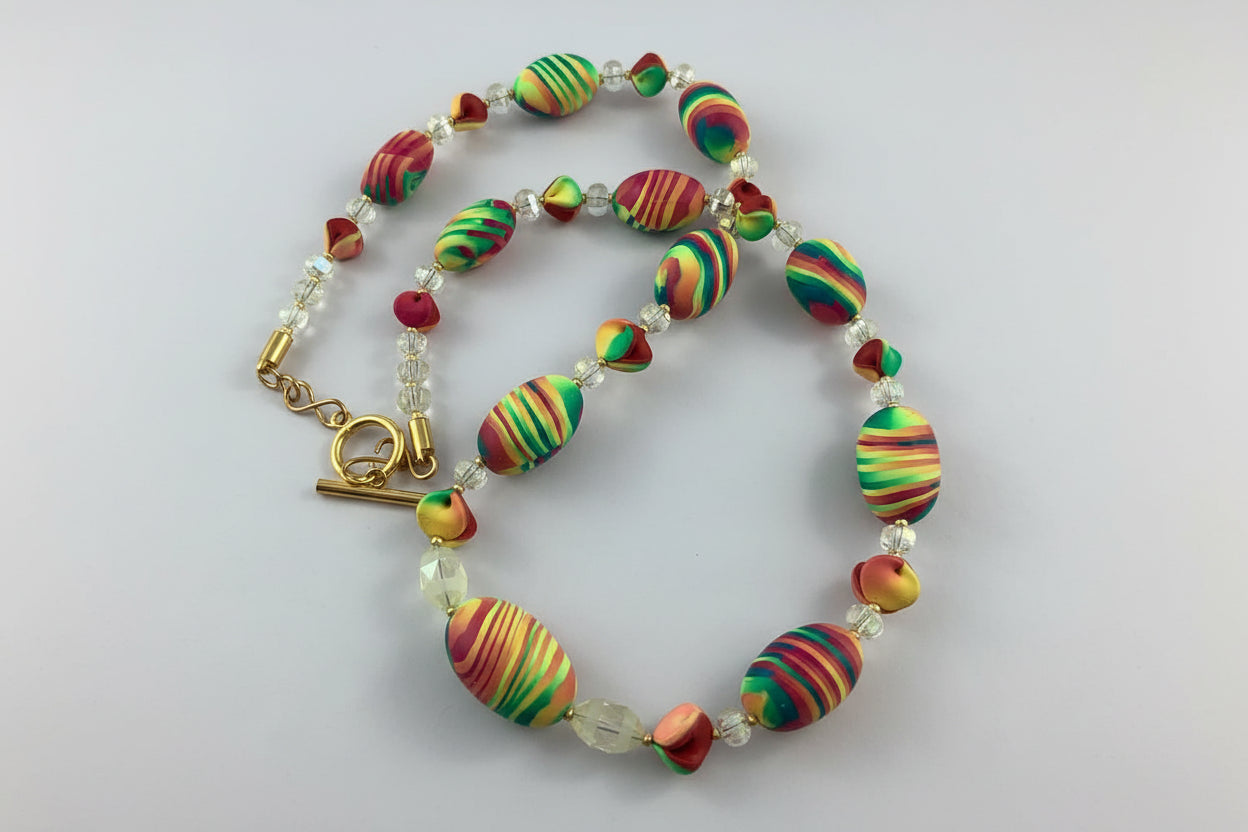 Video showcase of Rennique handmade multicolour necklace and bracelet jewellery set featuring vibrant artisan striped beads, crystal accents and bold statement styling.