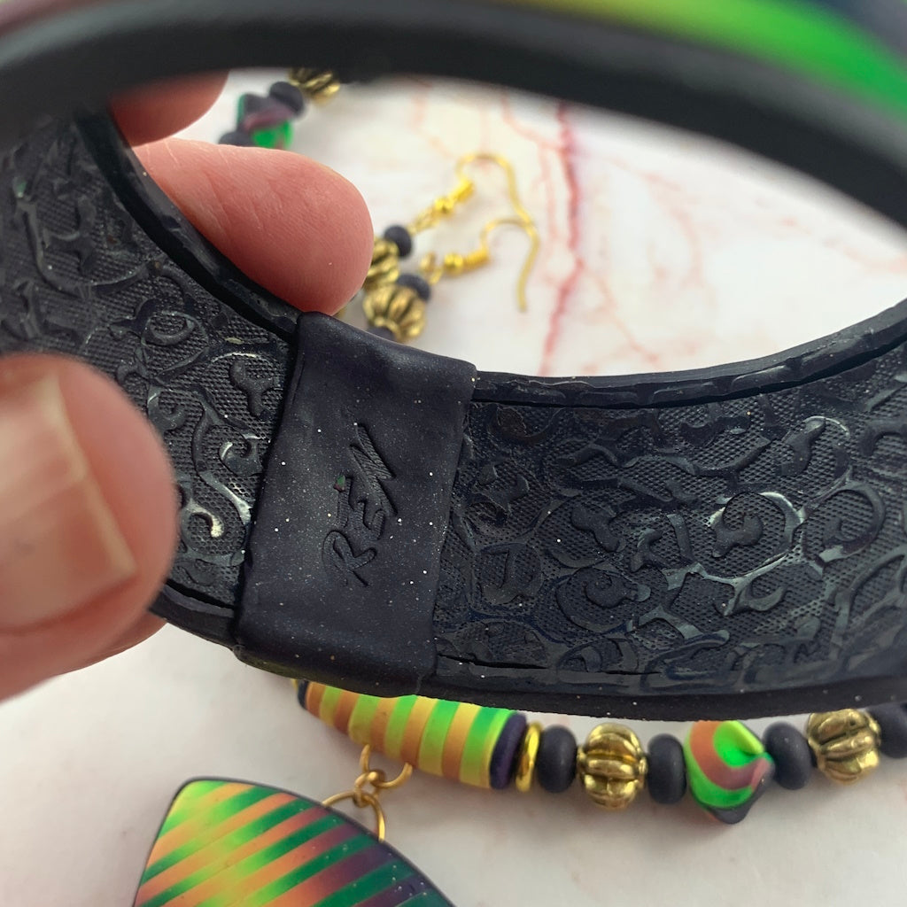 Close up of Rennique signature stamped interior on handcrafted ladies bracelet with textured finish.