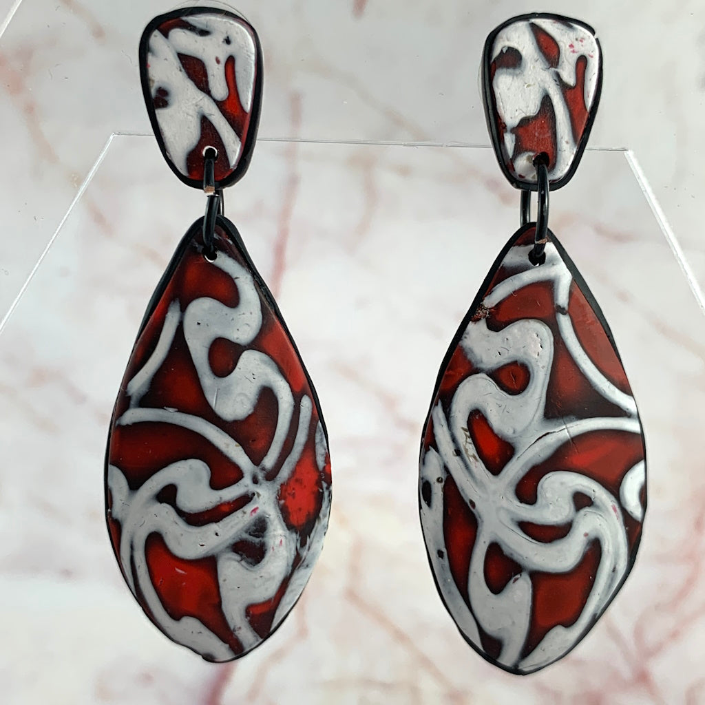 Red and white abstract teardrop statement earrings with black trim