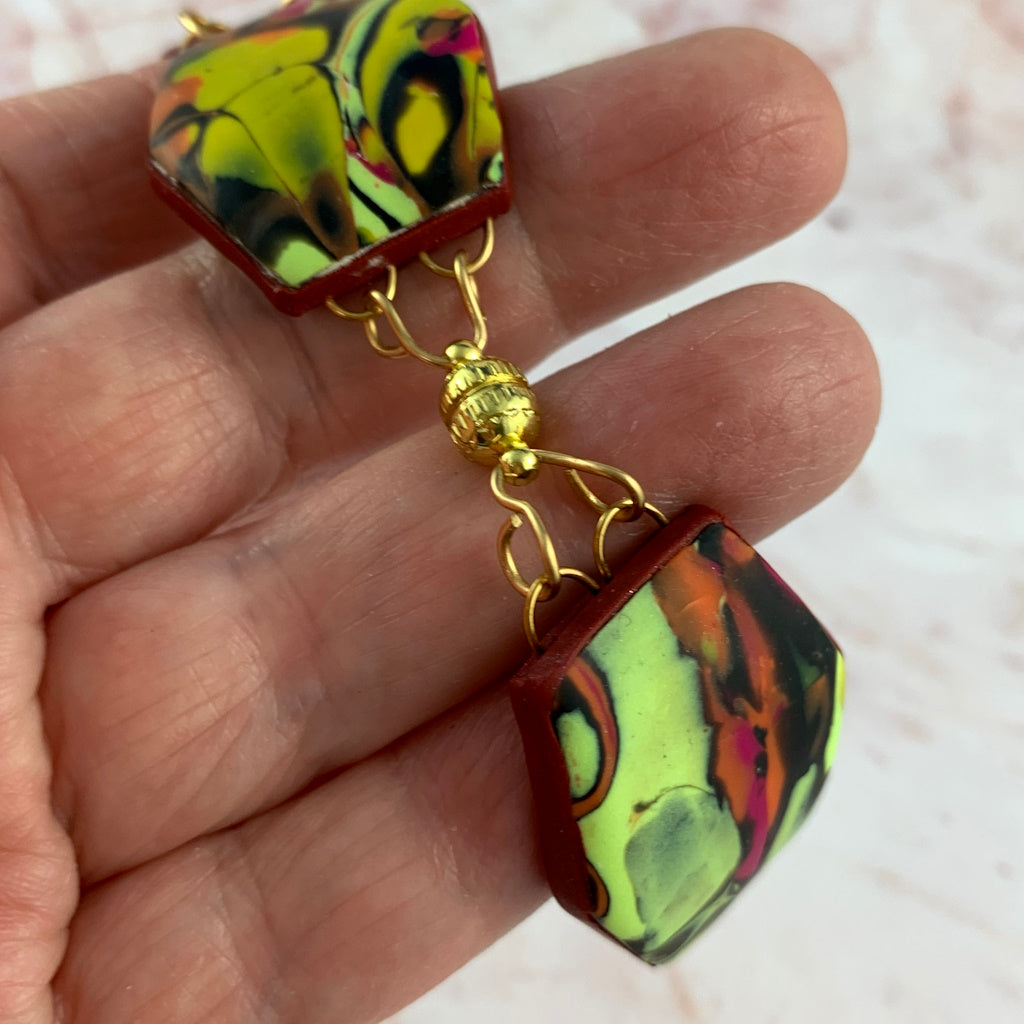 Side close-up of bracelet showing Curved polymer clay links and sculptural shape.